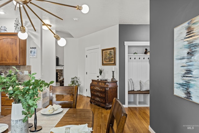 dining room with a textured ceiling and light wood-type flooring