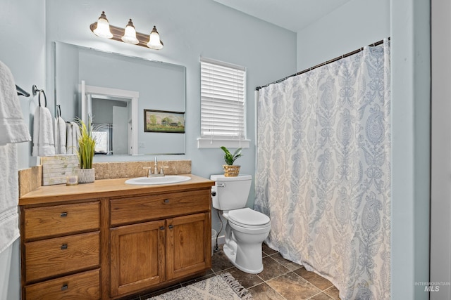 bathroom featuring vanity, toilet, and tile patterned flooring