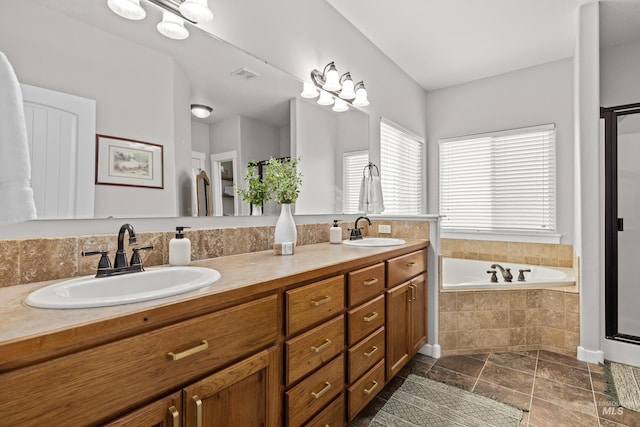 bathroom with vanity and tiled bath