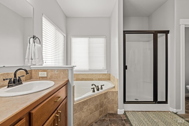 full bathroom featuring vanity, independent shower and bath, and toilet