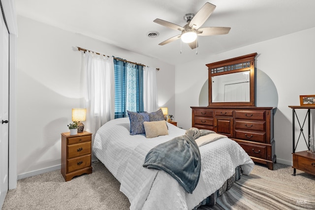 bedroom featuring light carpet and ceiling fan