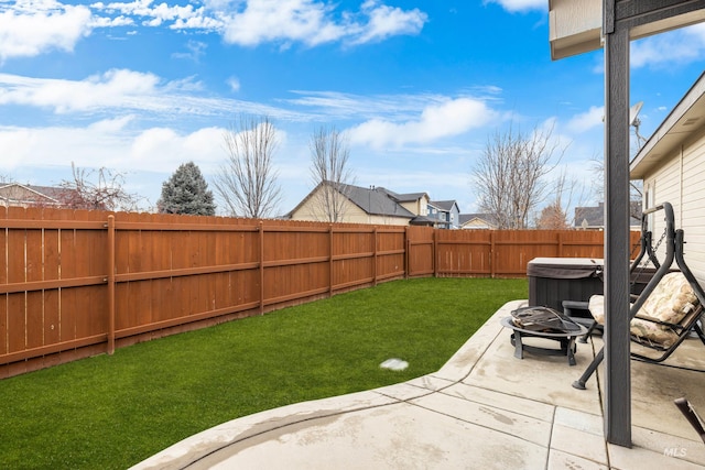 view of yard featuring a fire pit, a hot tub, and a patio