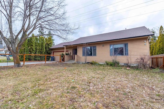 single story home featuring an attached garage, a front lawn, and fence