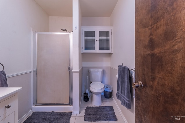 full bath featuring vanity, toilet, a shower stall, and tile patterned flooring