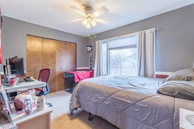 bedroom with a closet, light colored carpet, and ceiling fan