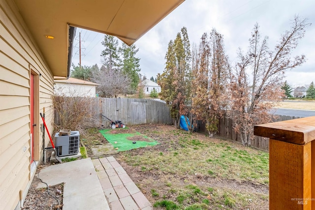 view of yard with a patio area, central air condition unit, and a fenced backyard