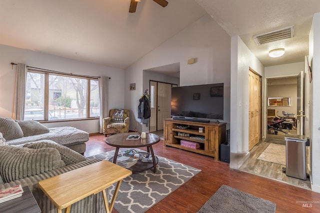 living room with visible vents, ceiling fan, lofted ceiling, and wood finished floors