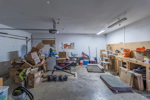 garage with a workshop area and a garage door opener