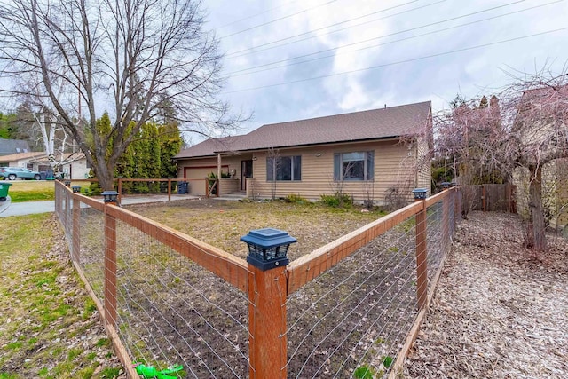 view of front of home featuring an attached garage and fence private yard