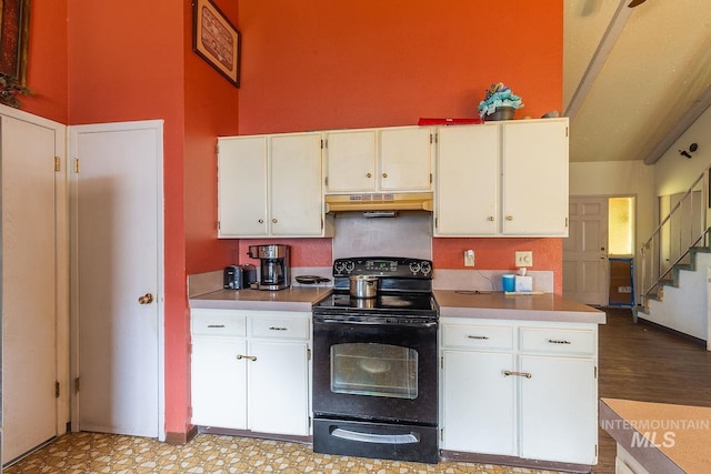 kitchen featuring white cabinetry, under cabinet range hood, light countertops, and black electric range oven