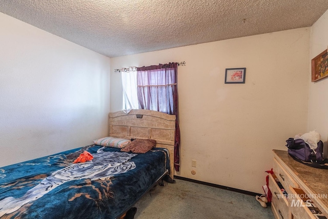 bedroom featuring a textured ceiling, baseboards, and carpet floors