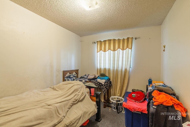 bedroom with carpet and a textured ceiling