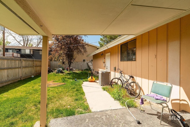view of yard with fence and central AC unit