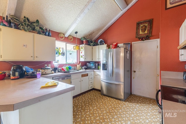 kitchen featuring stainless steel appliances, vaulted ceiling with beams, light countertops, a textured ceiling, and light floors