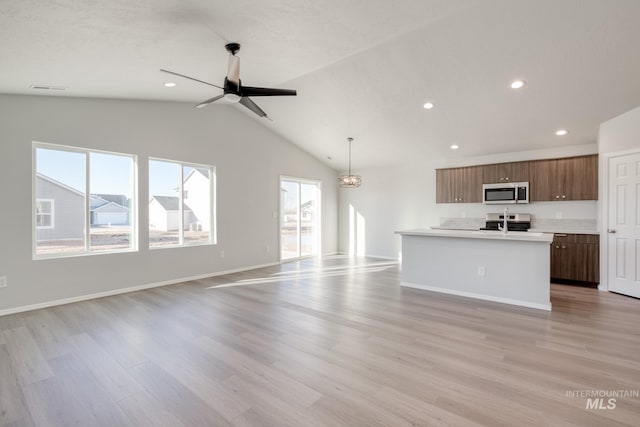 unfurnished living room with ceiling fan, light hardwood / wood-style flooring, and lofted ceiling