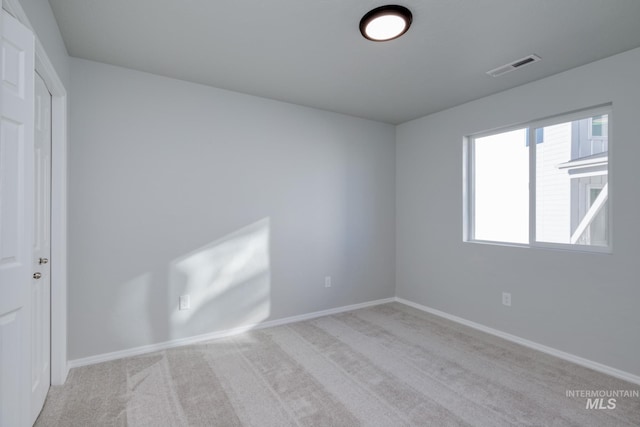 unfurnished room with light carpet