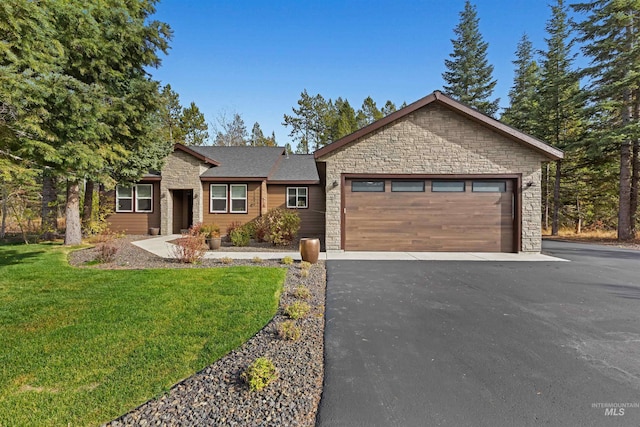 view of front of home with a garage and a front lawn