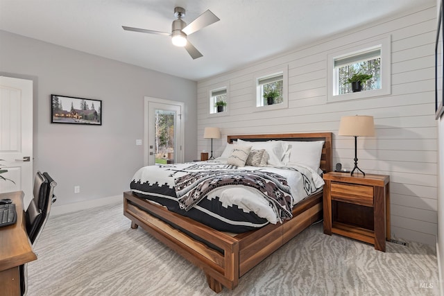 bedroom featuring light carpet, multiple windows, access to outside, and ceiling fan