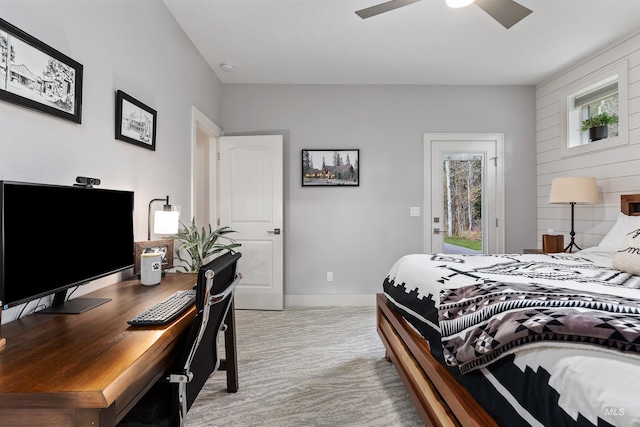 bedroom with wooden walls, multiple windows, access to outside, and ceiling fan