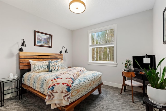 bedroom with dark colored carpet