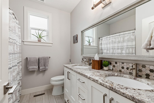 bathroom featuring vanity and toilet