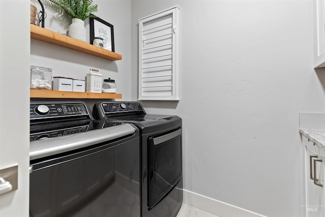 washroom featuring washer and dryer and light tile patterned flooring