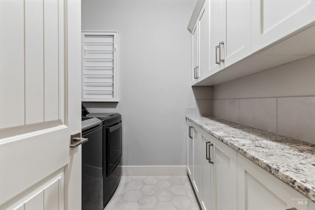 laundry room with cabinets, separate washer and dryer, and light tile patterned floors