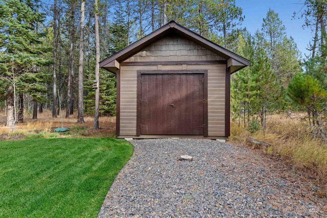 view of outbuilding featuring a yard