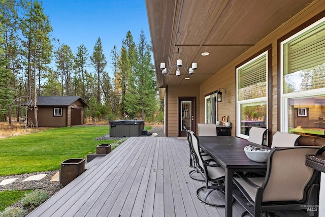 wooden terrace featuring a hot tub, a shed, and a yard