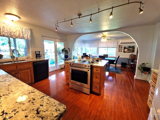 27406 Gem Ln, Juliaetta, ID 83535 - kitchen featuring dishwasher, stainless steel electric range, brown cabinets, track lighting, and a textured ceiling
