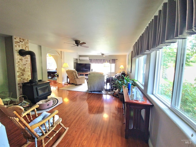 27406 Gem Ln, Juliaetta, ID 83535 - living room with a wood stove, ceiling fan, wood finished floors, and arched walkways