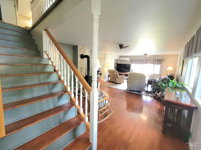 27406 Gem Ln, Juliaetta, ID 83535 - stairway featuring wood finished floors, ceiling fan, and arched walkways