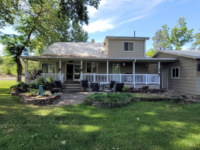 27406 Gem Ln, Juliaetta, ID 83535 - farmhouse featuring covered porch and a front lawn