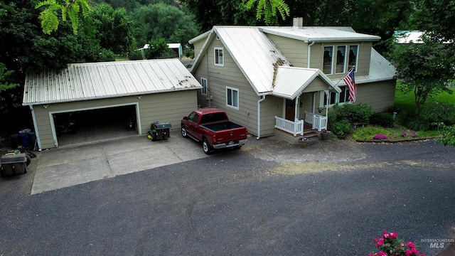 27406 Gem Ln, Juliaetta, ID 83535 - view of front of home featuring an outbuilding, a metal roof, asphalt driveway, and a porch