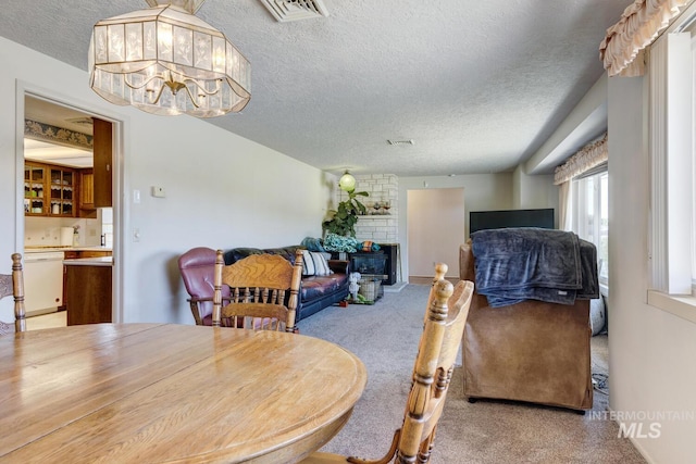 11360 W Lake Hazel Rd, Boise, ID 83709 - carpeted dining room with a textured ceiling, a chandelier, and a fireplace