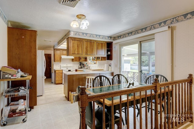 11360 W Lake Hazel Rd, Boise, ID 83709 - dining space with light floors, a chandelier, and a textured ceiling