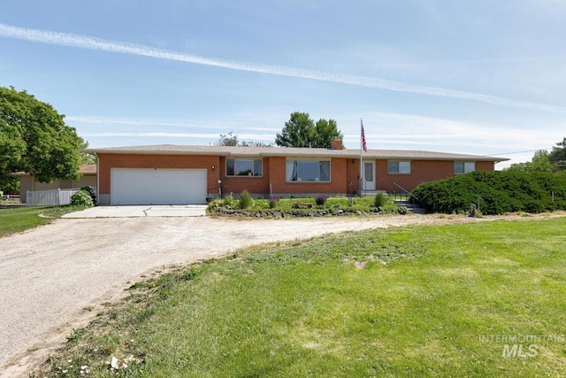 11360 W Lake Hazel Rd, Boise, ID 83709 - single story home with dirt driveway, a garage, brick siding, and a front lawn
