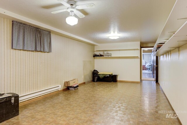 11360 W Lake Hazel Rd, Boise, ID 83709 - basement featuring baseboards, ceiling fan, and a baseboard radiator