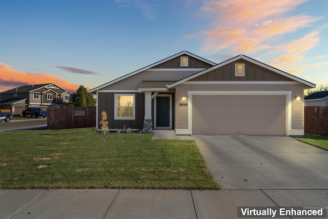 view of front of house with a yard and a garage