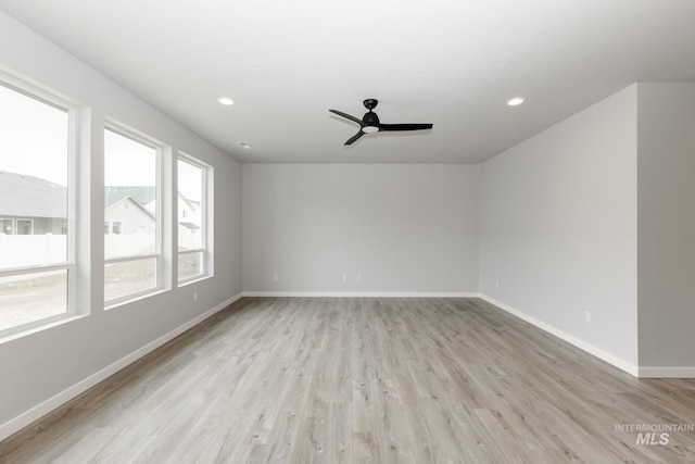 spare room featuring ceiling fan and light wood-type flooring