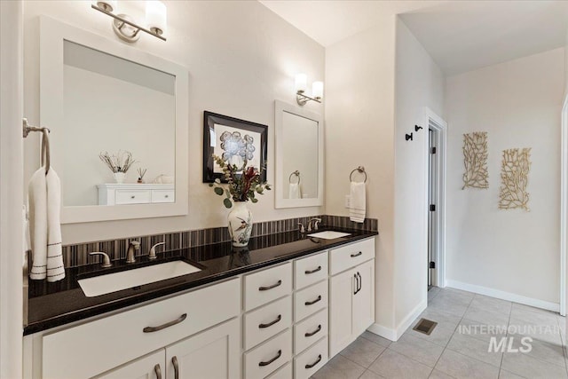 bathroom featuring tile patterned floors, visible vents, a sink, and double vanity