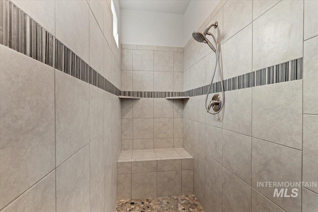 interior details with a tile shower