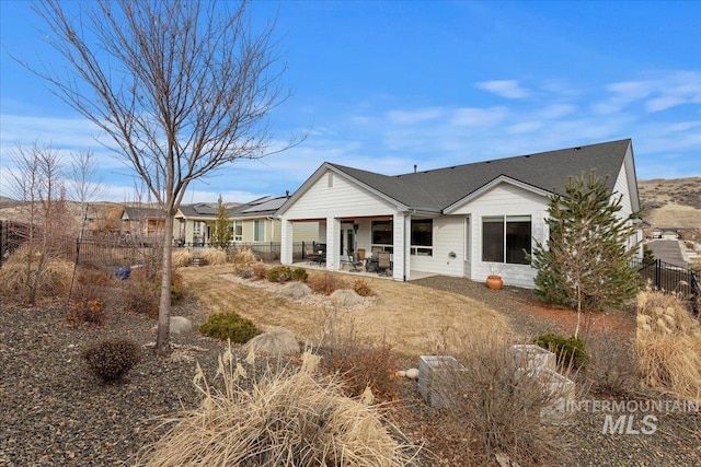 view of front of home with fence and a patio