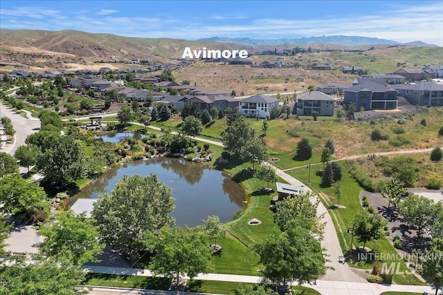 birds eye view of property with a residential view and a water and mountain view