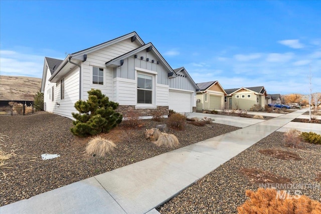 view of front of house with a garage, concrete driveway, and board and batten siding