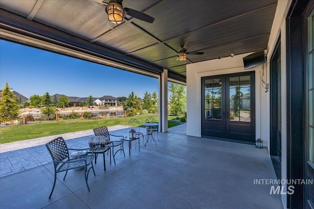 view of patio / terrace featuring ceiling fan and french doors