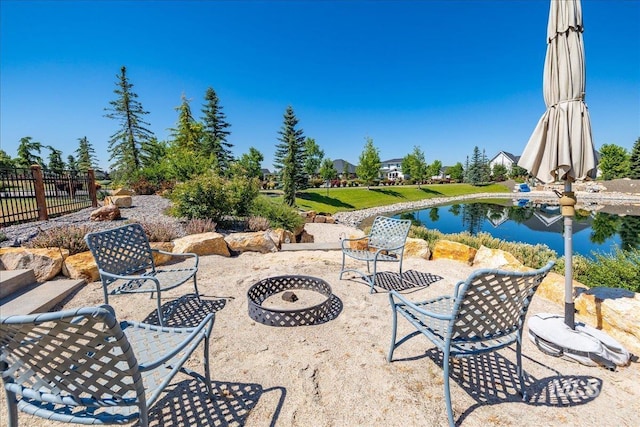 view of patio / terrace featuring a water view and an outdoor fire pit