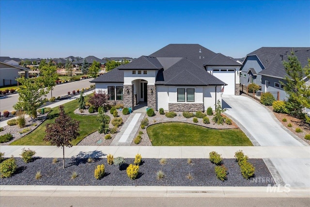 view of front of house with a front yard and a garage