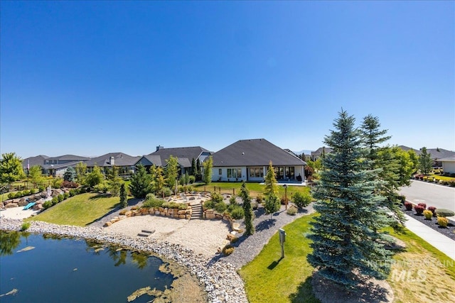 exterior space featuring a water view and a yard