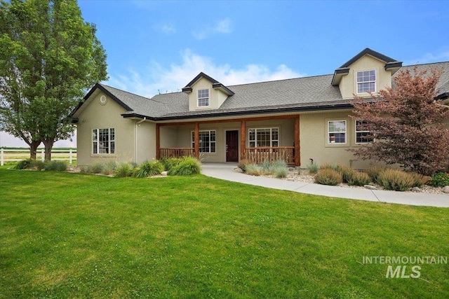 view of front of house with a porch, a front yard, and stucco siding